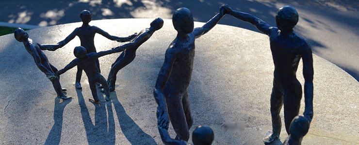 Statues of people holding hand in circle